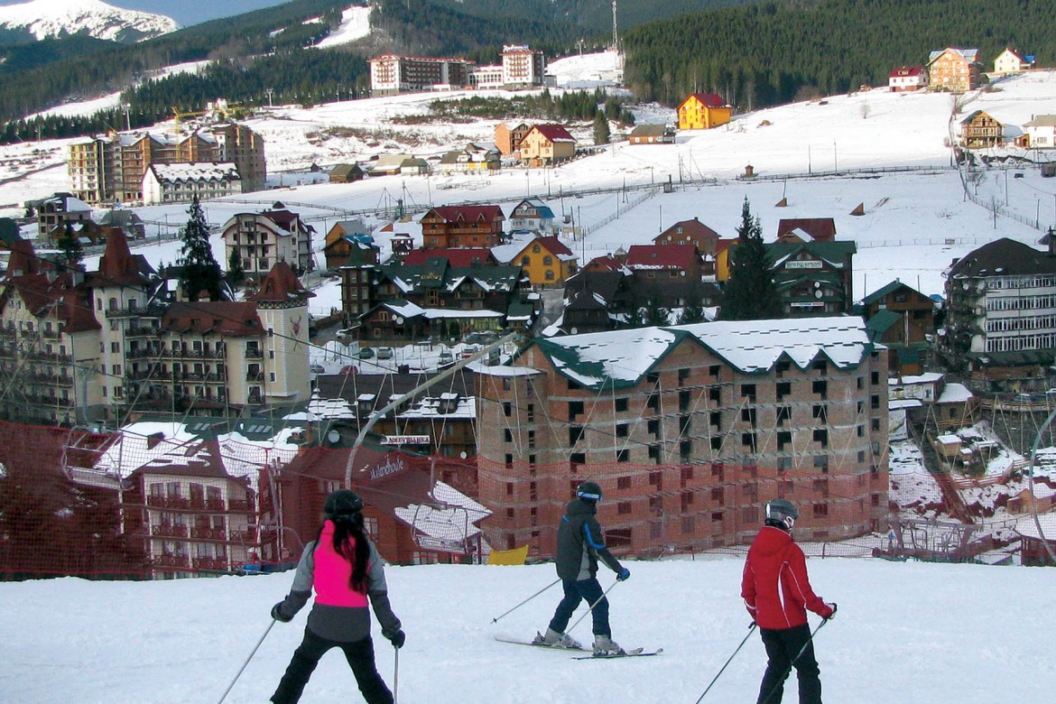 Skiers descend on a Bukovel ski slope overlooking the village resort.