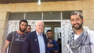In the film “Red Lines,” Mouaz Moustafa (far right) is seen bringing Sen. John McCain to Syria.