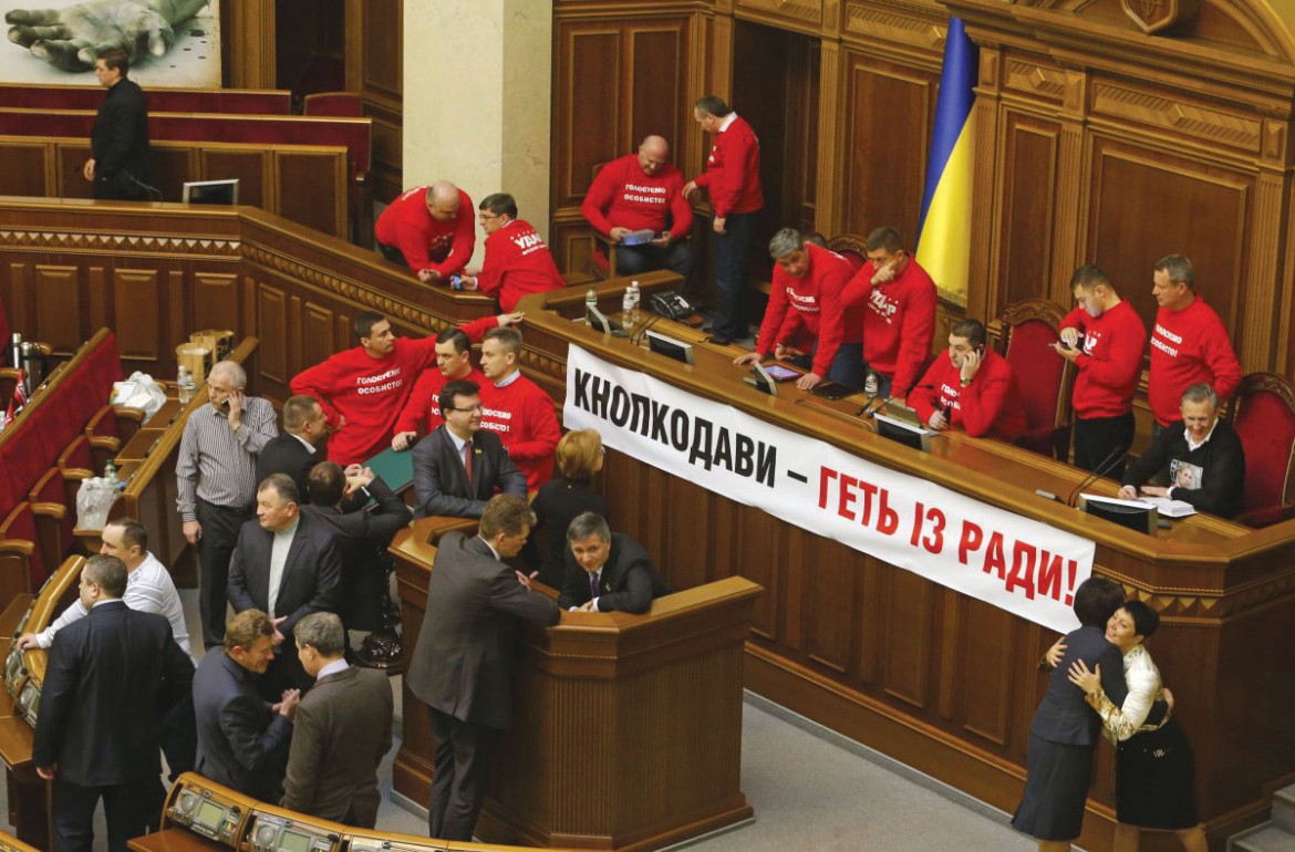 Members of UDAR block the rostrum in the Verkhovna Rada on February 6 to protest “piano voting.”