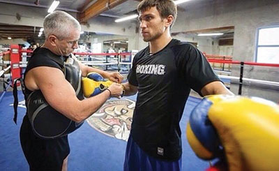 Featherweight Vasyl Lomachenko get his gloves secured by a trainer in preparation for his May 2 fight in Las Vegas against Gamalier Rodriguez of Puerto Rico.