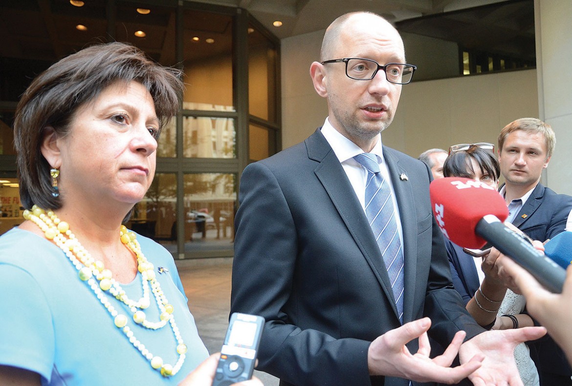With Finance Minister Natalie Jaresko standing beside him in front of the International Monetary Fund headquarters building, Prime Minister Arseniy Yatsenyuk recounts the Ukrainian military and economic issues discussed during their three days of talks in Washington.