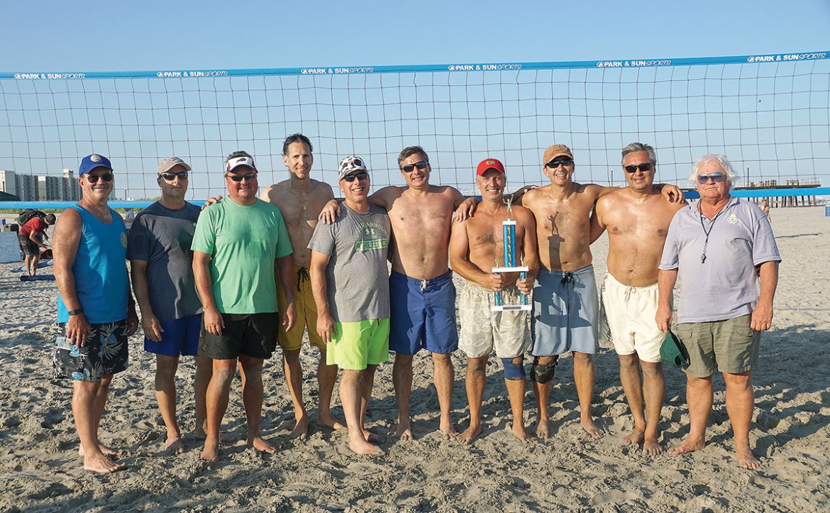 2015 USCAK Beach Volleyball Finalists “Sitch - Moutai” (second to fifth from left) and 2015 USCAK Beach Volleyball Champions “Old Style Lite” (second to fifth from right) with USCAK tournament organizers.