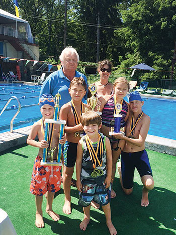 Swimmers pose with trophies and medals that were awarded by Myron Bytz and Taissa Bokalo.