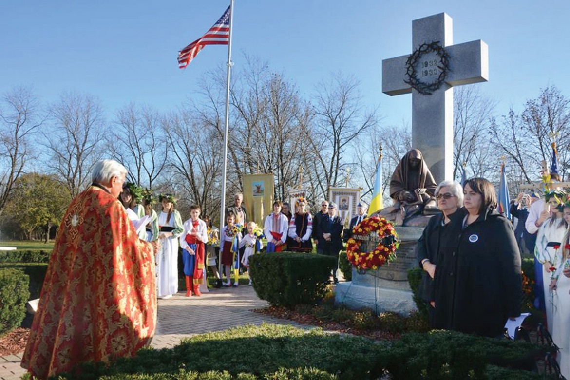 The Very Rev. Mitered Protopriest Victor Poliarny of St. Andrew Ukrainian Orthodox Cathedral – Kyivan Patriarchate, prays before the monument dedicated to the memory of the 10 million victims of the Holodomor. 