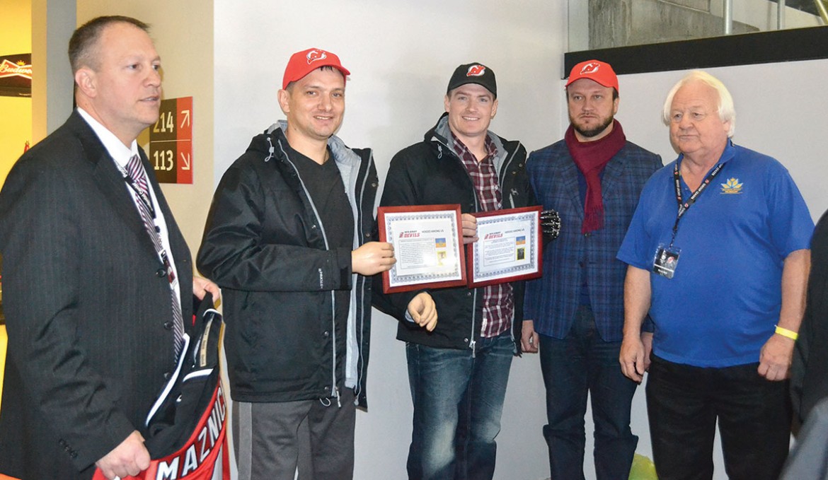 Being recognized during the Devils game as “Heroes Among Us” are Vadim Sviridenko (second from left) and Vadym Maznichenko (center). With them (from left) are: Devils Vice-President Jim Leonard, Consul General Igor Sybiga and Myron Bytz, Ukrainian Heritage Day coordinator.