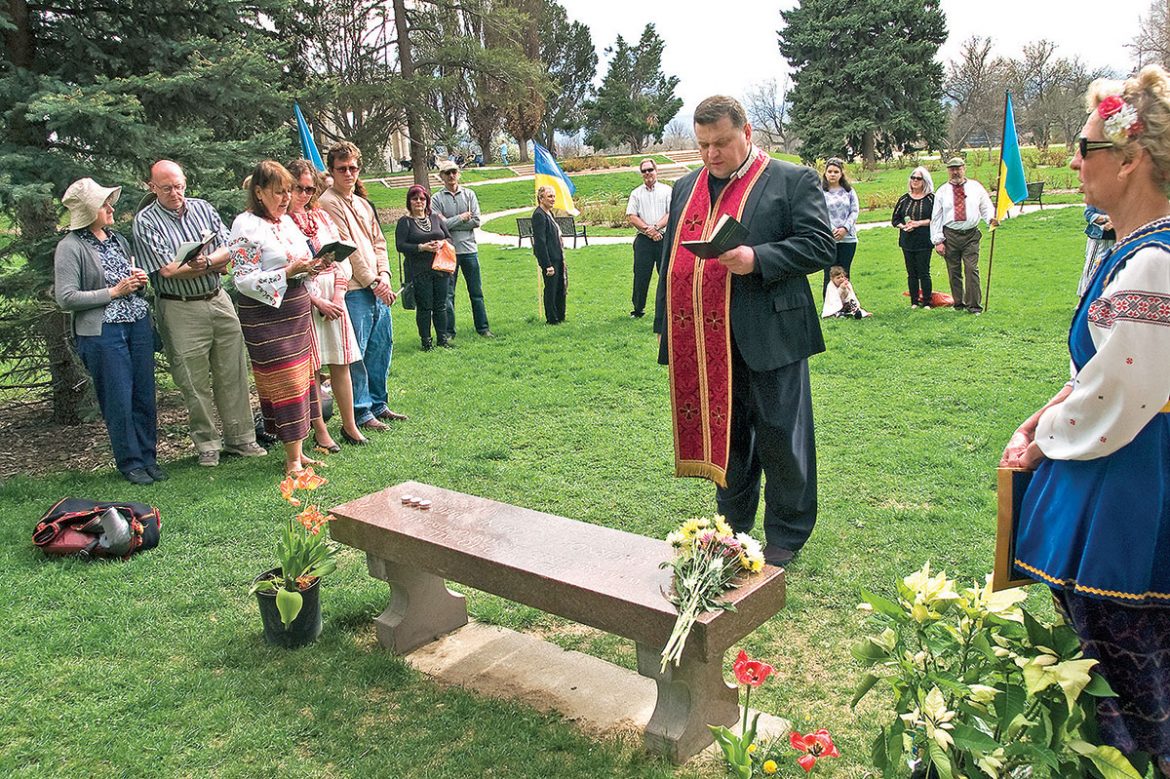 The Rev. Vasyl Hnatkivsky of the Transfiguration Ukrainian Greek-Catholic Church in Denver officiates at a memorial service in Denver’s Cheesman Park.