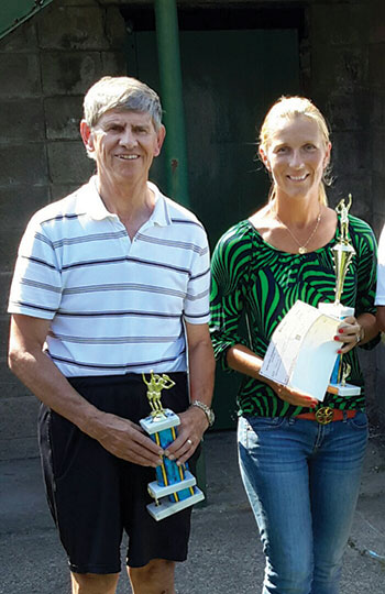 The women’s trophy winner Lesia Bilak Schinnerer receives a stipend from Winner-Ukraine and a UNA trophy from Ivan Durbak. 