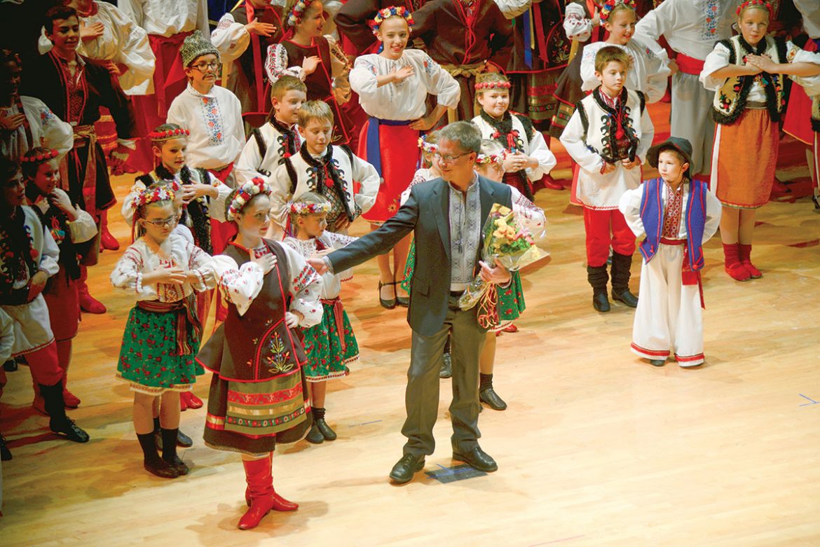 Artistic Director Andrij Cybyk leads the dancers in a group bow.