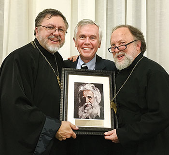 University of St. Michael’s College President David Mulroney is flanked by Father Andriy Chirovsky (left) and Father Peter Galadza.