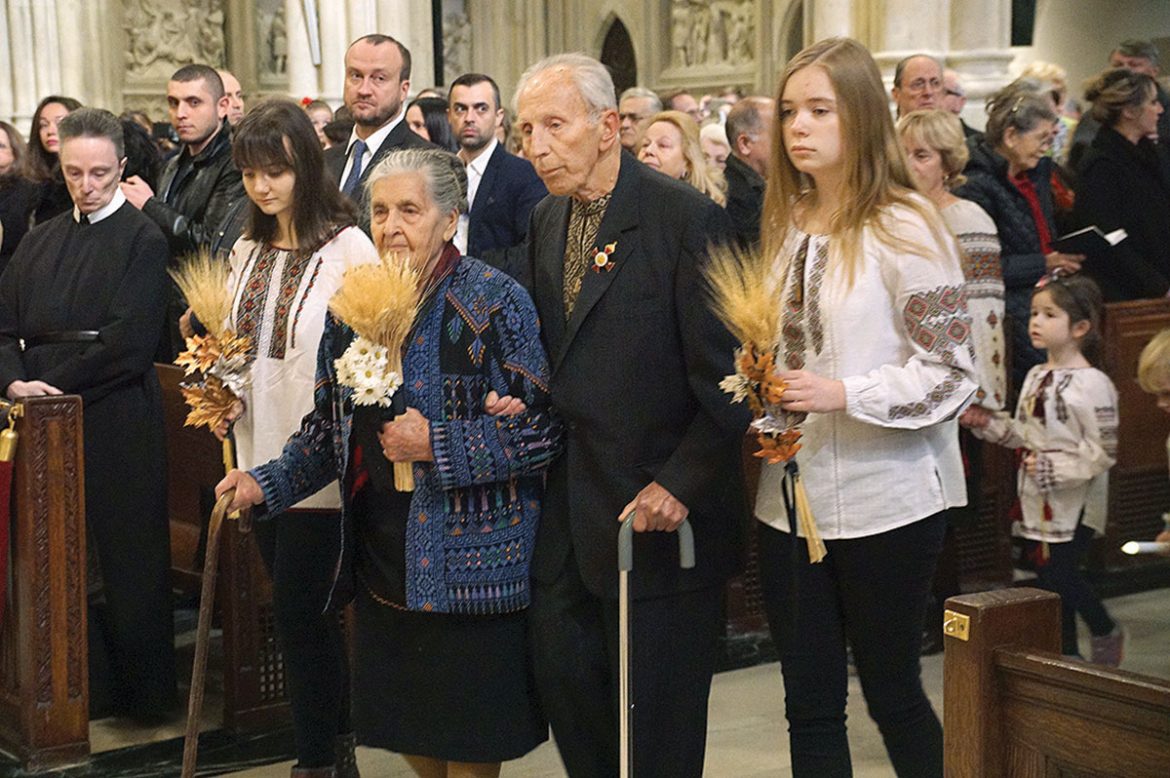 Holodomor survivors Nadia and Alexander Severyn are escorted in the solemn  procession.