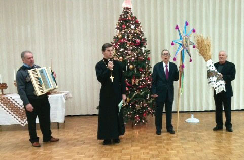 Orest Popovich carries the star of Bethlehem and John Bortnyk carries the didukh. With them is the Rev. Volodymyr Popyk.