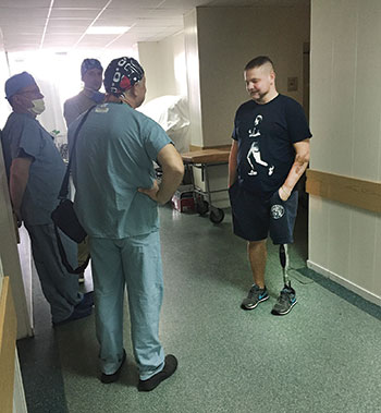 Andriy Usach, a paratrooper wounded from a rocket barrage while defending the Luhansk Airport on July 17, 2014, speaks to Canadian doctors prior to follow-up surgery on his jaw in Kyiv.