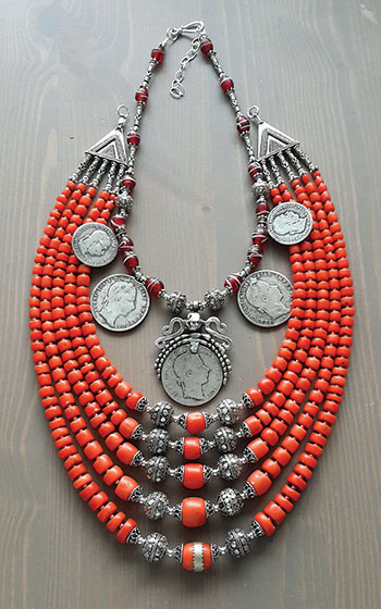 Another necklace by Slava Salyuk incorporates antique red coral, sterling silver beads, vintage red flower Venetian trade beads and antique silver Austrian coins of the late 1800’s. The “dukach” features a silver pendant with a Franz Josef coin. 