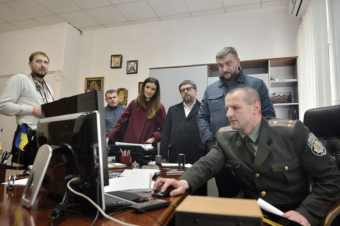 A deputy warden (seated) at the Lukyanivska Prison gives a presentation via computer to Justice Minister Pavlo Petrenko (background) and (next to him) Deputy Justice Minister Denys Chernyshov on April 18 in Kyiv. 