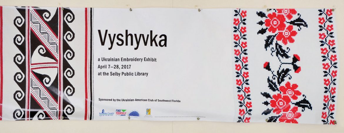 The 10-by-3-foot banner at the outside entrance of Selby Public Library that was designed by the library for the exhibit of Ukrainian embroidery.