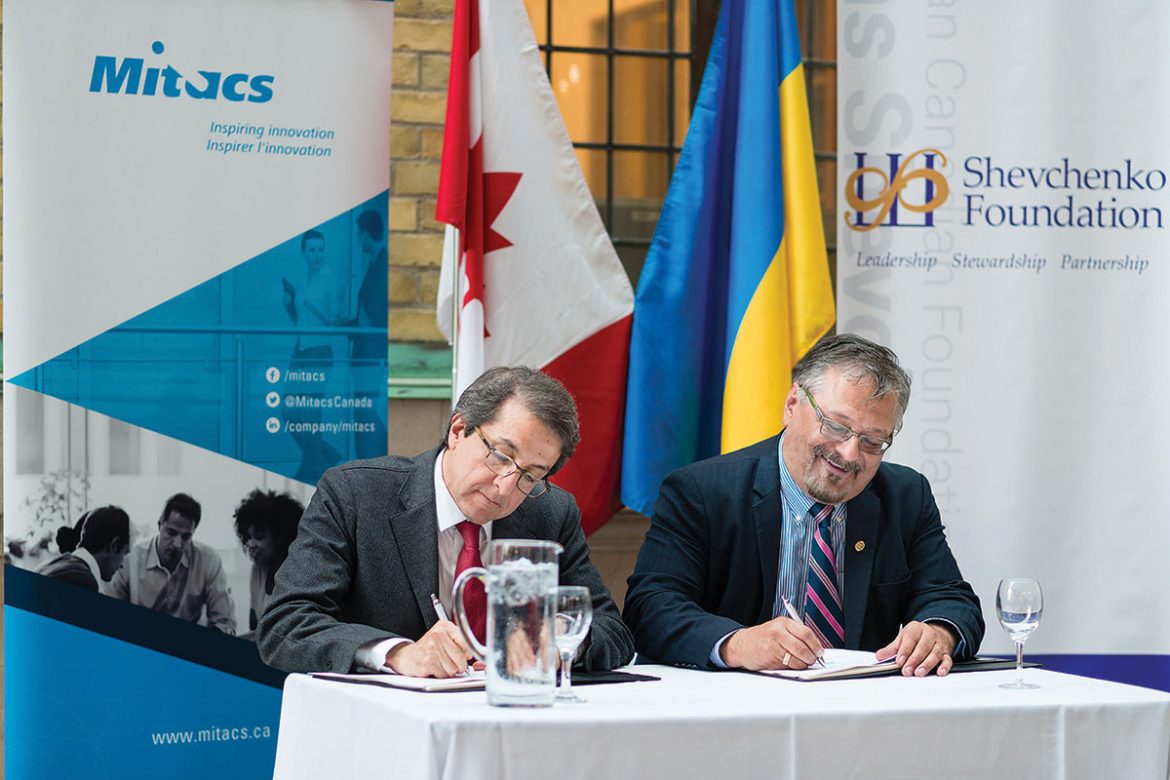 Alejandro Adem, Mitacs CEO and scientific director, and Andrew Hladyshevsky, president of the Shevchenko Foundation, signing a partnership agreement.