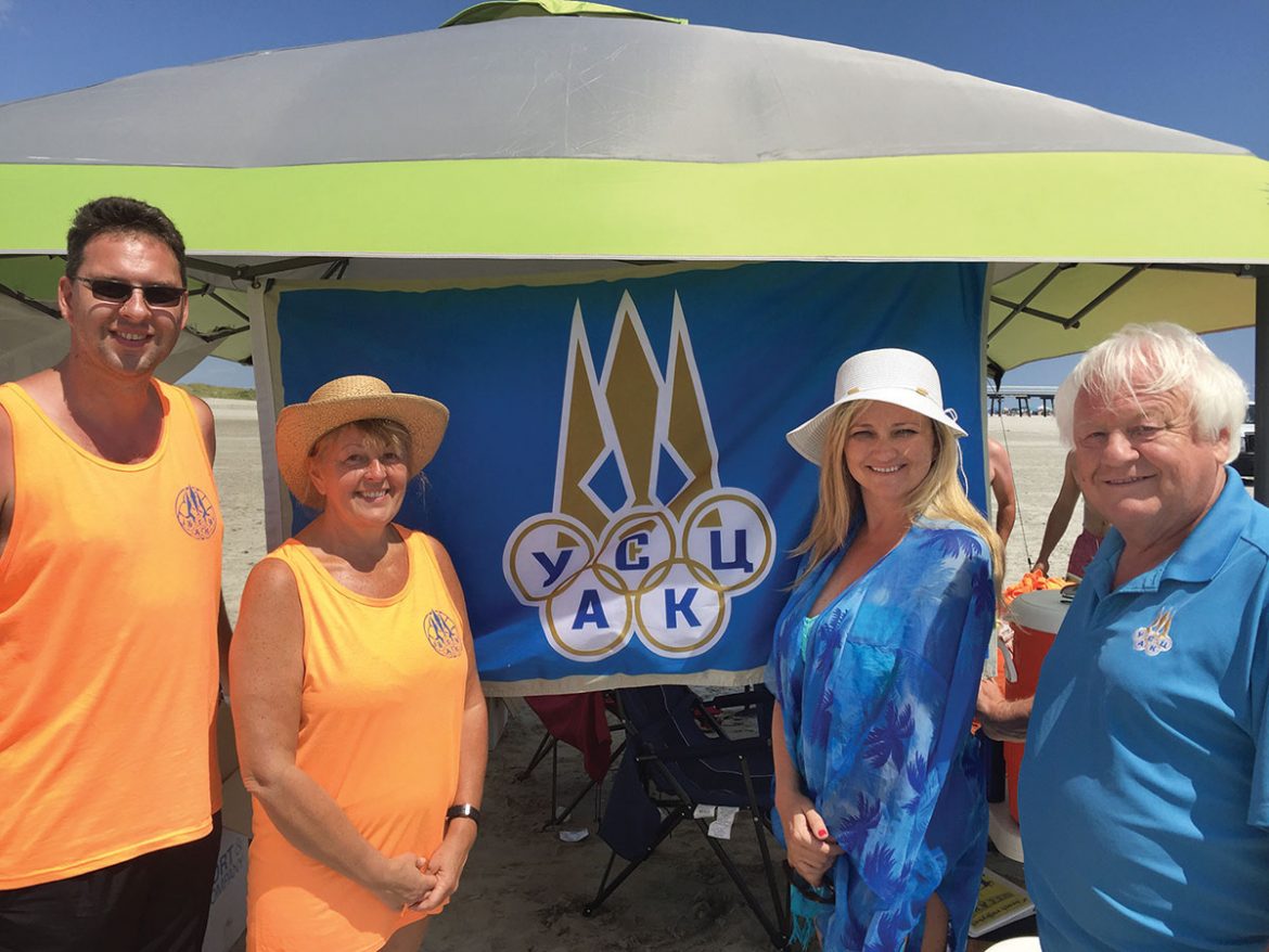 At the beach volleyball tournament (from left) are: Roman Bulawski, tournament organizer; Mary Kolodij, director and president, and Oxana Holubowsky, treasurer, both of Ukrainian Selfreliance Federal Credit Union, a sponsor of the tournament; and Myron Bytz, president of the Ukrainian Sports Federation of the U.S.A. and Canada.