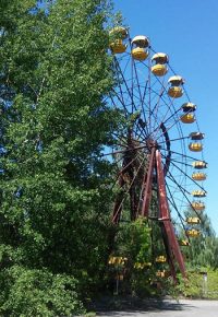 Overgrowth partially conceals a merry-go-round at the abandoned amusement park in Prypiat, a town of once 50,000 people, that was built simultaneously with the Chornobyl Nuclear Power Plant to house its employees and auxiliary workers.  (CREDIT: Mark Raczkiewycz)